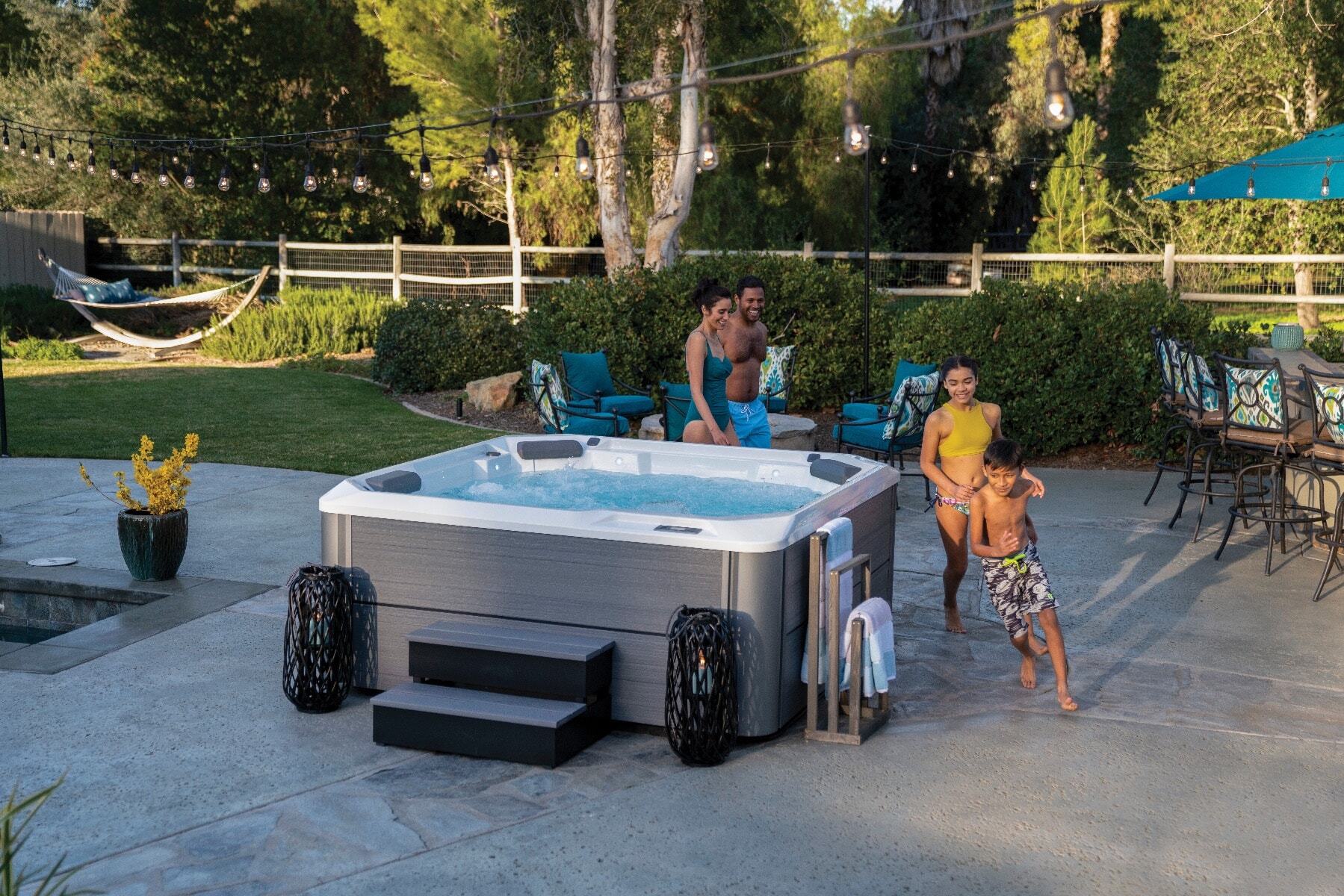 A family relaxing in a HotSpring Hot Spot Relay hot tub on an afternoon